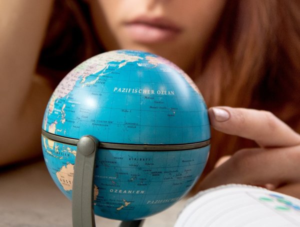 Reiseplanung an einem kleinen Globus - © Foto: Franziska Gabbert/dpa-tmn