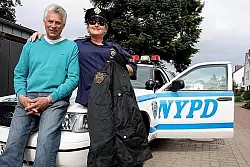 Ulli und Gundi Lohmeier vor ihem Polizeiauto. Gundi Lohmeier tr&auml;gt Hemd und M&uuml;tze der New Yorker Polizei. - &copy; FOTO: KIENSCHERF