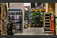 Blick in die Halle: Rechts ist eines der Filmsets zu erkennen, hinten stehen Plastikblumen und links finden sich weitere Bauelemente. - © Daniel Salmon