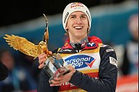 Daniel Tschofenig aus Österreich hält die Trophäe der 73. Vierschanzentournee. - © Georg Hochmuth/APA/dpa