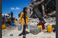 Vertriebene Palästinenser holen im Flüchtlingslager Jabalia im nördlichen Gazastreifen mit Kanistern Wasser. - © Mahmoud Zaki/XinHua/dpa