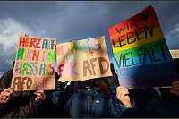 Bunter Protest: Teilnehmende einer Protestaktion unter dem Motto «Menschenkette gegen die AfD und ihre menschenfeindliche Politik» demonstrieren mit bunten Schildern in Hamburg. - © Christian Charisius/dpa