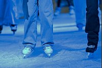 Vergnügen in der kühlen Jahreszeit: Am Tag der Eröffnung der Eisbahn am Filmpark Babelsberg steht eine Person mit Schlittschuhen auf dem Eis. - © Michael Bahlo/dpa