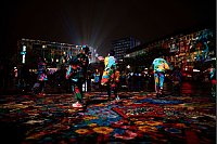 Besucher laufen durch die Projektion der „Big Picture“ des Künstler Daniel Margraf auf dem Kennedy-Platz beim „Essen Light Festival“ - © Fabian Strauch/dpa