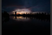 Die Zentrale der Europäischen Zentralbank (EZB) hebt sich im letzten Licht des Tages vor dem Himmel ab. - © Boris Roessler/dpa