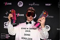 Sänger Ski Aggu hat gleich zweimal gewonnen. Nach der Verleihung des Musikpreises «1Live Krone» zeigt er seine Preise. - © David Inderlied/dpa