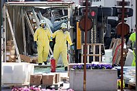 Die Einsatzkräfte nähern sich dem umgekippten Anhänger nur mit Atemschutzmasken. - © FOTO: DPA