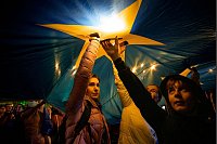 Demonstranten leuchten mit ihren Mobiltelefonen auf einen Stern einer großen EU-Flagge während einer Pro-EU-Kundgebung vor der zweiten Runde der Präsidentschaftswahlen in Rumänien. - © Andreea Alexandru/AP/dpa