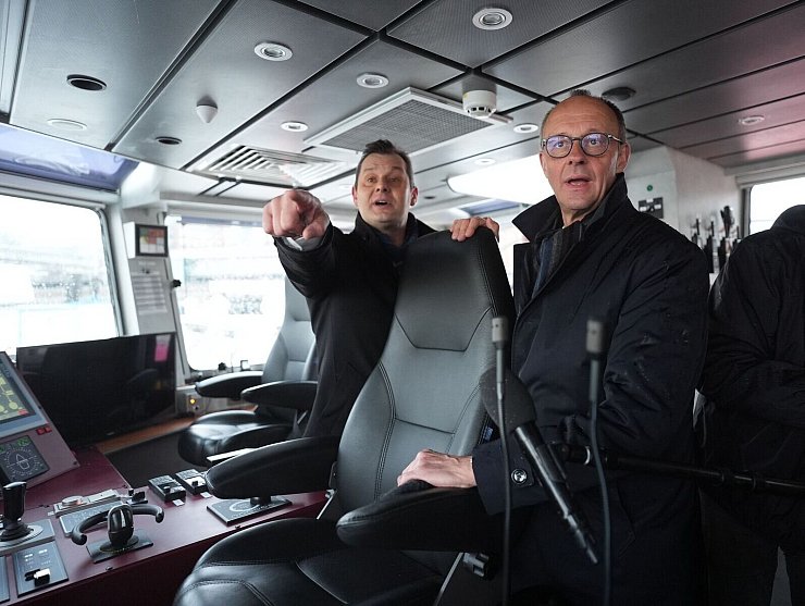 Unionskanzlerkandidat Friedrich Merz lässt sich vom Inhaber des Hamburger Unternehmens VB Group beim Besuch des Feuerlöschboots «Prag» den Hamburger Hafen zeigen. - © Marcus Brandt/dpa Pool/dpa