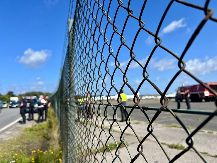 Am Flughafen Sylt sind Polizisten schnell zur Stelle, nachdem Klima-Aktivisten der Letzten Generation ein Loch in den Zaun geschnitten haben und auf das Gelände gelangt sind. - © Lea Sarah Albert/dpa