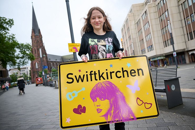 Die Stadt Gelsenkirchen wird im Juli Schauplatz für die «Eras Tour» von Superstar Taylor Swift - und gibt zu Ehren der Musikerin einen neuen Namen. Enthüllt wurde das «Swiftkirchen» von Swift-Fan Aleshanee Westhoff. - © Bernd Thissen/dpa