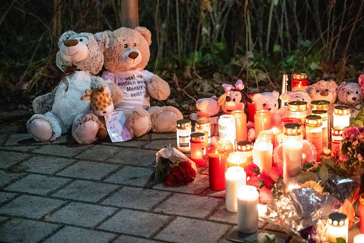 Nach tödlichem Angriff in einem Park in Aschaffenburg: Zwei Teddybären und zahlreiche Kerzen stehen im Park Schöntal. - © Daniel Vogl/dpa