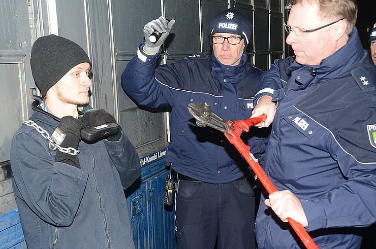 Die vier angeketteten Personen wurden durch sachkundige Polizisten und Feuerwehrleute befreit. - © FOTO: ANDREAS EICKHOFF
