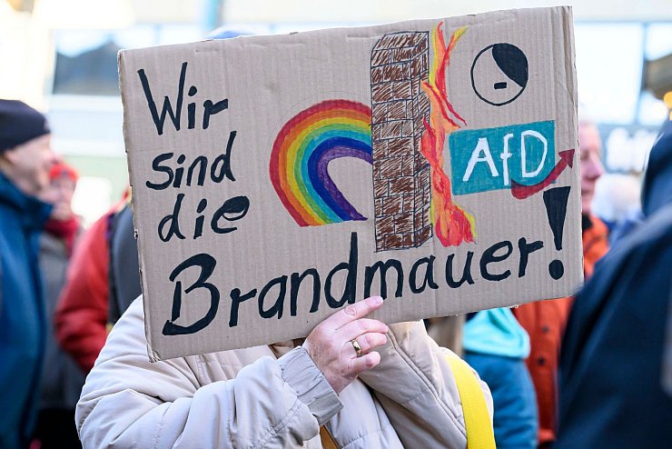 In Frankfurt erinnert eine Demonstrantin an die Brandmauer. - © Salome Roessler/dpa