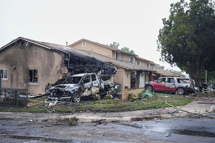 Häuser wurden bei dem Absturz in Brand gesetzt. - © Gregory Bull/AP/dpa