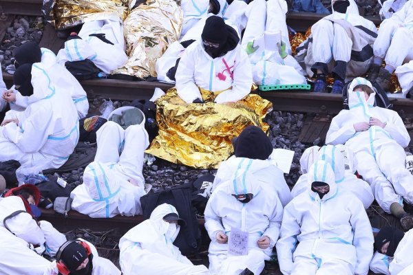 Klimaschutzaktivisten des Bündnisses Ende Gelände blockieren in weissen Overalls die Schienen einer Zufahrt zu dem Kohlekraftwerk Scholven in Gelsenkirchen. - © David Young/dpa