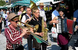 Die Musik des "Kozma Orkestar" begleitete den ersten Markttag bei strahlendem Sonnenschein. Um die Musiker herum gab es frische Erdbeeren, Tomaten, Spargel und Salat. - &copy; FOTO: BARBARA FRANKE
