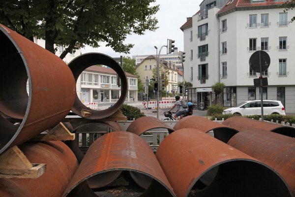 Warten auf ihren Einsatz im Untergrund: Diese Stahlröhren lagern momentan noch auf dem kleinen Platz am Ende der Freyastraße. Im Hintergrund sind die Röntgenstraße und das Klinikum zu sehen. - © Bernhard Preuss