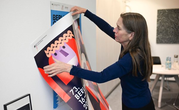 Mariette Rissenbeek, Geschäftsführerin der Berlinale, hängt Filmfestival-Büro am Potsdamer Platz das neue Berlinale-Plakat auf. - © Jens Kalaene/dpa