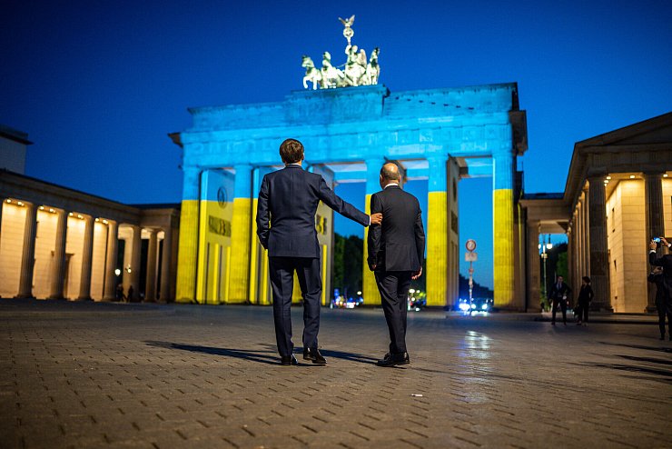 Bundeskanzler Olaf Scholz und Frankreichs Pr&auml;sident Emmanuel Macron vor dem Brandenburger Tor - in geschichtstr&auml;chtiger Pose. - &copy; picture alliance/dpa | Michael Kappeler