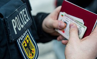 Ein Beamter der Bundespolizei hält bei einer Kontrolle ausländische Ausweise in den Händen. - Marc Müller/dpa Ein Beamter der Bundespolizei hält bei einer Kontrolle ausländische Ausweise in den Händen. - Marc Müller/dpa