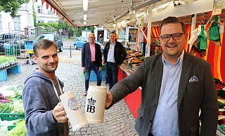 Maximilian Janski, Vorsitzender des Schötmaraner Bürgervereins, stößt mit Andreas Plaß, Vorsitzender des Wochenmarktvereins, an dessen Gemüsestand an. Im Hintergrund André Schröder, stellvertretender Vorsitzender des Bürgervereins (links) und Oliver Siekmann vom Stadtmarketing. - Alexandra Schaller Maximilian Janski, Vorsitzender des Schötmaraner Bürgervereins, stößt mit Andreas Plaß, Vorsitzender des Wochenmarktvereins, an dessen Gemüsestand an. Im Hintergrund André Schröder, stellvertretender Vorsitzender des Bürgervereins (links) und Oliver Siekmann vom Stadtmarketing. - Alexandra Schaller