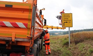 Die Arbeiter wechseln die Wegweiser für die Barntruper Umgehung aus. - Nadine Uphoff