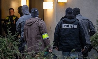 Maskierte Polizisten dursuchen das Wohnhaus der früheren RAF-Terroristin Daniela Klette in Berlin-Kreuzberg. - Monika Skolimowska/dpa