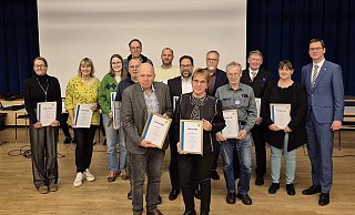 Bürgermeister Matthias Kalkreuter (rechts) verabschiedet (hinten, von links) Anika Jedlicka (CDU), Monika Kuhlmann (Grüne), Benita Henning (FDP), Peter Lohmann (Grüne), Torsten Riekehof (CDU), Benjamin Tiedt (Grüne), Christoph Löhning (CDU), Klaus Schmiedekamp (FWG/BBL), Reimund Neumann (Grüne), Axel Wiebusch und Loreen Scheibe (beide SPD) sowie (vorne) Erhard Kirchhof und Angelika Schapeler-Richter. - Lorraine Brinkmann