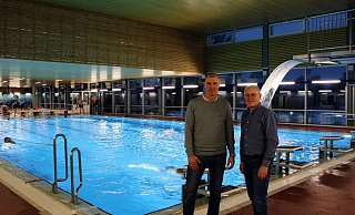 Badleiter Frank Niegsch (links) und Fachbereichsleiter Frank Rayczik zeigen, was sich in den vergangenen Jahrzehnten getan hat. Der Wasserfall am 3-Meter-Turm ist das Highlight im Bad. - Lorraine Brinkmann