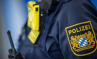 Eine Polizistin trägt ein Abzeichen der bayerischen Polizei. - Daniel Karmann/dpa/Symbolbild Eine Polizistin trägt ein Abzeichen der bayerischen Polizei. - Daniel Karmann/dpa/Symbolbild