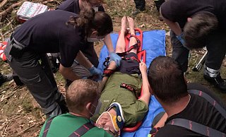 Der Mountainbiker Marco Brokbartold wird von Helfern des DRK und der Freiwilligen Feuerwehr Bad Salzuflen nach seinem Sturz im Wald betreut. Er klagt über starke Rückenschmerzen und ist auf Insulin angewiesen. Zum Glück ist dieses nur eine großangelegte Übung. - Foto: Daniel Hobein / Feuerwehr Bad Salzuflen