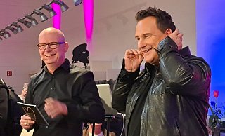 Am Abend auf der Bühne hat Guido Maria Kretschmer (rechts, mit Marco-Tozzi-Geschäftsführer Christian Böhm) leichte Probleme mit dem Mikrofon - doch Hilfe kommt sofort. Zuvor hat die LZ den Designer getroffen. - Carolin Brokmann-Förster
