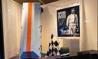 Das Schaufenster seines Hauses, das ehemalige „Altenbernd-Haus“ an der Hauptstraße, hat Bestatter Heilmann mit einem Sarg mit Rallye-Streifen, einer Carrera-Bahn und einem Bild von Steve McQueen dekoriert. - Horst Biere Das Schaufenster seines Hauses, das ehemalige „Altenbernd-Haus“ an der Hauptstraße, hat Bestatter Heilmann mit einem Sarg mit Rallye-Streifen, einer Carrera-Bahn und einem Bild von Steve McQueen dekoriert. - Horst Biere