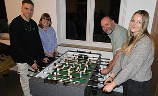 Profi-Fußballer Felix Platte vom SC Paderborn 07 stellt sich für ein aussagekräftiges Publikum gern an den Kicker des SOS-Kinderdorfes mit dem Leitungteam Laura Hesse, Holger Busch und Gillian König (von links). - Hajo Gärtner