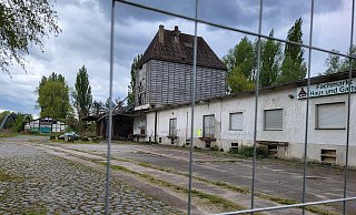 Blick auf die Brandruine in der Ladestraße. Hier hat sich seit dem Großfeuer augenscheinlich kaum etwas verändert. Offen liegen verbrannte Abfälle auf dem Gelände herum (im Hintergrund). - Freya Köhring