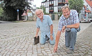 Wolfgang Sieweke (links) und Werner Kuloge versuchen, den Unterschied im Pflaster zu erfühlen. Optisch ist er kaum zu erkennen. - Nadine Uphoff