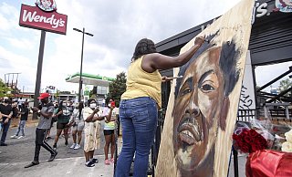 Eine Künstlerin malt ein Bild des Opfers Rayshard Brooks. - Foto: Steve Schaefer/Atlanta Journal-Constitution/AP/dpa