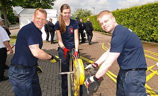 Mit vereinten Kräften wickelt das Horn-Bad Meinberger Trio den Schlauch auf, der zuvor zum Löschangriff eingesetzt wurde: (von links) Hauptfeuerwehrmann Maik Kalous, Unterbrandmeisterin Rebecca Hennemann und Unterbrandmeister Nils Hammelmann. - Hajo Gärtner