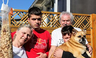 Die Pflegefamilie vereint: (von links) Mutter Kornelia, Eugen (24), Vater Detlef und der zwölfjährige Timmi (Name geändert), der sich auf Wunsch der leiblichen Mutter extra ein wenig hinter dem Familienhund versteckt. - Janet König