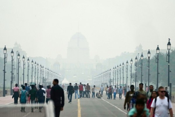 Menschen auf einer in Smog gehüllten Straße in Neu Delhi. (Archivbild) - © Manish Swarup/AP/dpa