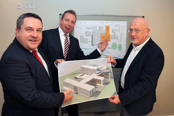 Perspektiven für das Klinikum: Dr. Axel Lehmann, Dr. Johannes Hütte und Dr. Helmut Middeke (von links) zeigen die Ausbaupläne für den Standort Detmold. Die orangen Erweiterungen auf dem Grundriss liegen auf dem Luftbild vorn. Der neue OP-Bereich dockt an den Querriegel an, auf der vorderen Projektskizze ist er auf der linken Seite als graues Quadrat zu sehen. - © Bernhard Preuss