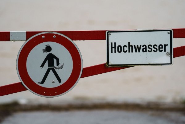 Ein Hochwasser-Schild steht an einem überfluteten Feld. - © Andreas Arnold/dpa/Symbolbild