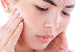 Frau hat Kieferschmerzen - Christin Klose/dpa-tmn