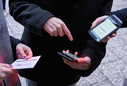 Ein Mann zeigt auf einen QR-Code den eine Frau Scannt - Annette Riedl/dpa/dpa-tmn