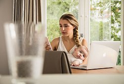Eine Frau sitzt mit ihrem Baby am Computer - Christin Klose/dpa-tmn