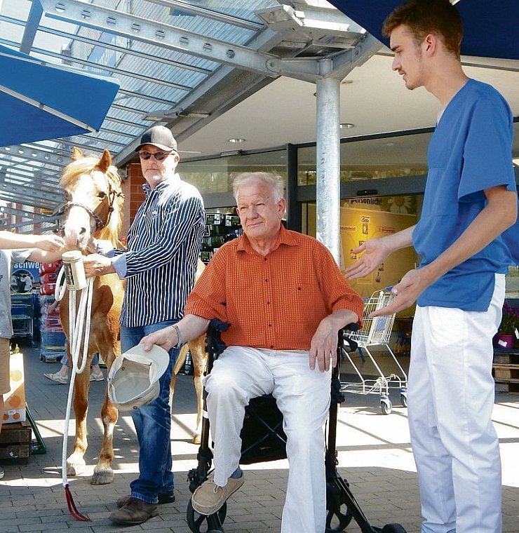 Provozierende Szene: Für das Pony von Stephan Zessel wird Geld gespendet. Ein älterer Mann (gespielt von Werner Brakensiek), der auf seinem Rollator sitzt, und sein Pfleger (Leo Sieker) gehen dagegen leer aus. - © Kerkhoff