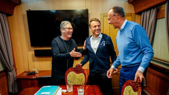 Auf dem Weg nach Kiew besprechen sich Pr&auml;sident Emmanuel Macron, Bundeskanzler Friedrich Merz und Premierminister Keir Starmer - und wegen der anwesenden Presse r&auml;umt Macron noch schnell etwas vom Tisch, was sp&auml;ter f&uuml;r Ger&uuml;chte sorgt. - &copy; Kay Nietfeld/dpa