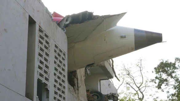Trümmer der Boeing 787-8 Dreamliner ragen aus einem Gebäude. - © Ajit Solanki/AP/dpa