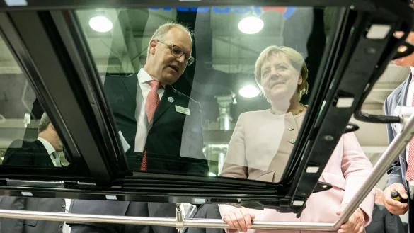 Der scheidende Webasto-Chef Holger Engelmann in besseren Tagen im Jahr 2019. Hier demonstriert der Manager der früheren Bundeskanzlerin Angela Merkel in einem Werk im chinesischen Wuhan die Fertigung von Schiebedächern. - © Michael Kappeler/dpa